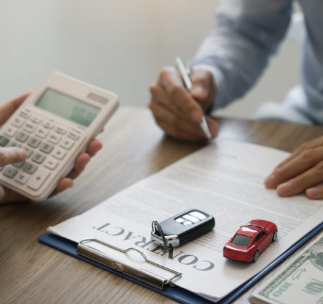 Finance manager of the car showroom is calculating the cost of reserving a new car for the customer while signing a car purchase contract.